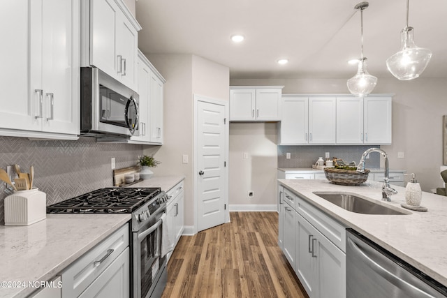 kitchen with white cabinetry, appliances with stainless steel finishes, and a sink