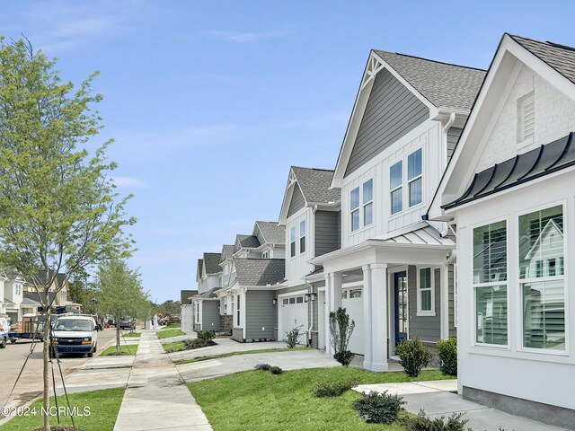 view of front of home featuring a porch and a garage