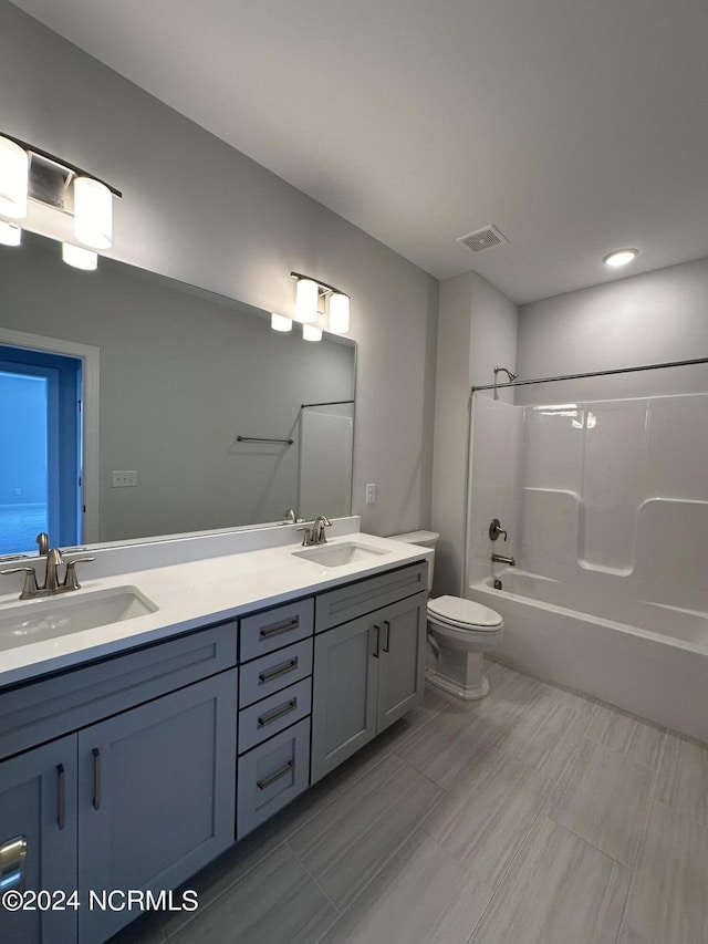 full bathroom featuring visible vents, a sink, shower / bathing tub combination, and double vanity