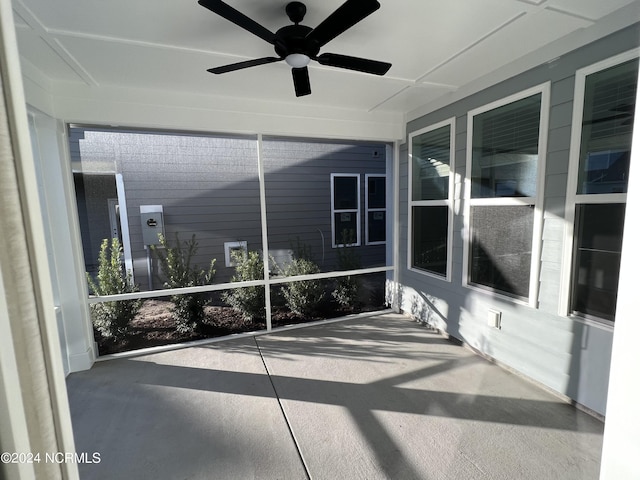 unfurnished sunroom featuring ceiling fan