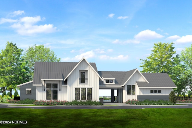 modern inspired farmhouse featuring board and batten siding, metal roof, and a front lawn