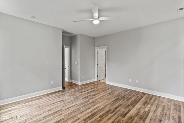 empty room with ceiling fan and hardwood / wood-style flooring