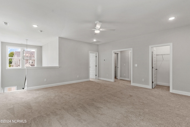 carpeted spare room featuring ceiling fan