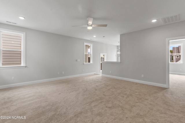 interior space featuring light colored carpet and ceiling fan