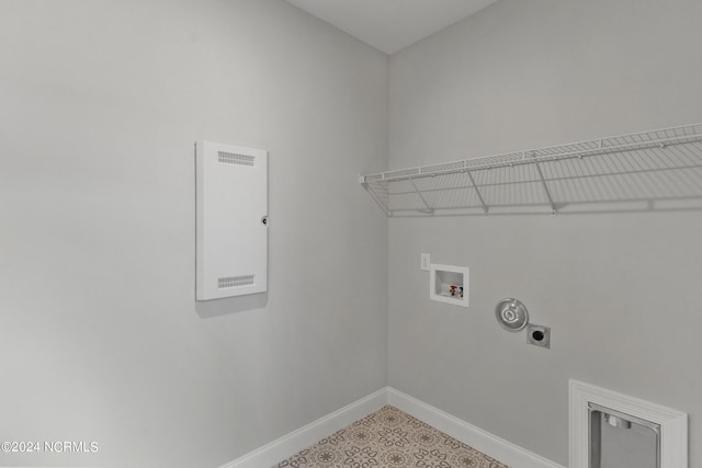 clothes washing area featuring hookup for a washing machine, electric dryer hookup, and tile patterned flooring