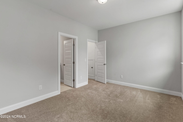 unfurnished bedroom with light carpet