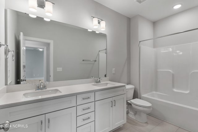 full bathroom with dual vanity, toilet, tile patterned floors, and shower / bath combination