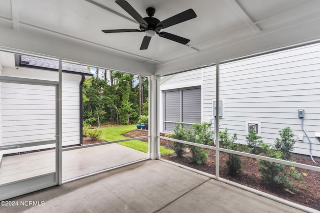 unfurnished sunroom with ceiling fan