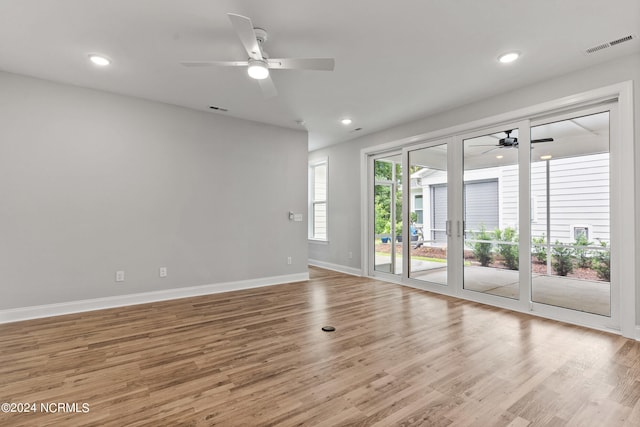 spare room featuring light hardwood / wood-style flooring, ceiling fan, and french doors