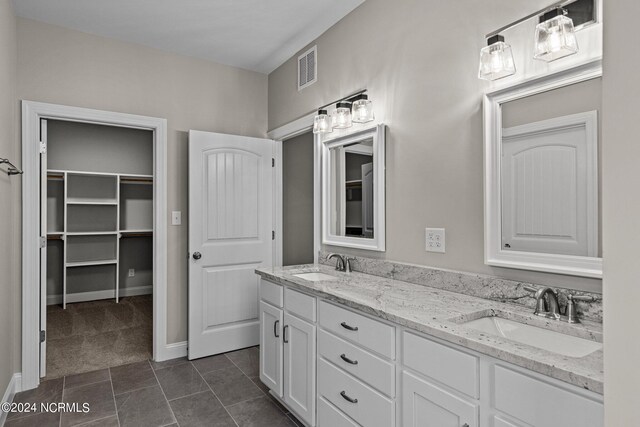 bathroom with tile patterned flooring and vanity