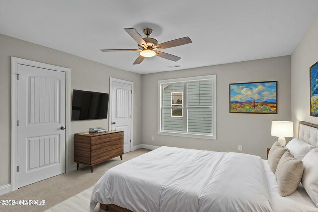 unfurnished bedroom featuring ceiling fan and light carpet