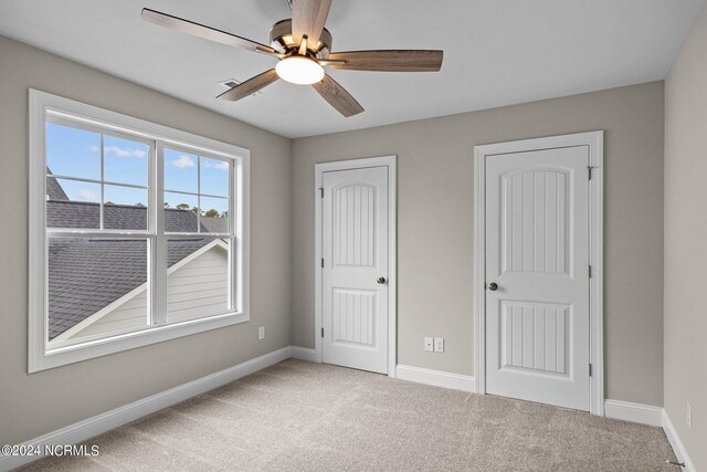 unfurnished bedroom with carpet flooring and ceiling fan