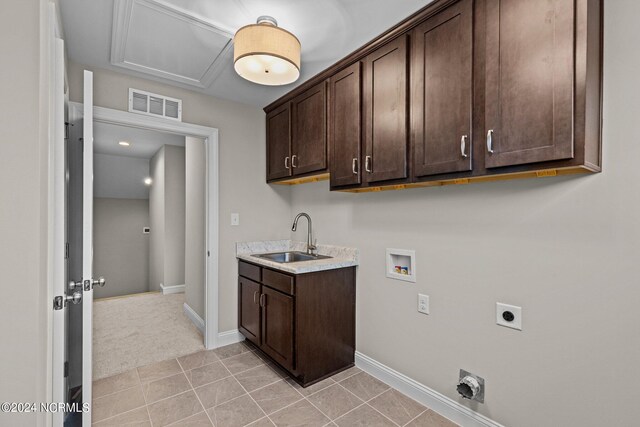 laundry room with hookup for an electric dryer, washer hookup, cabinets, sink, and light tile patterned flooring