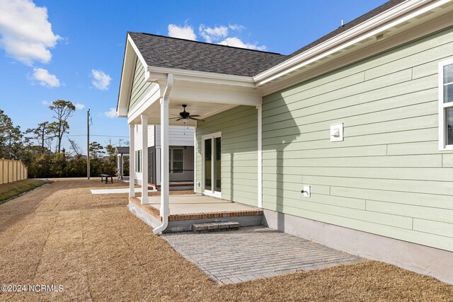 doorway to property featuring a patio and ceiling fan