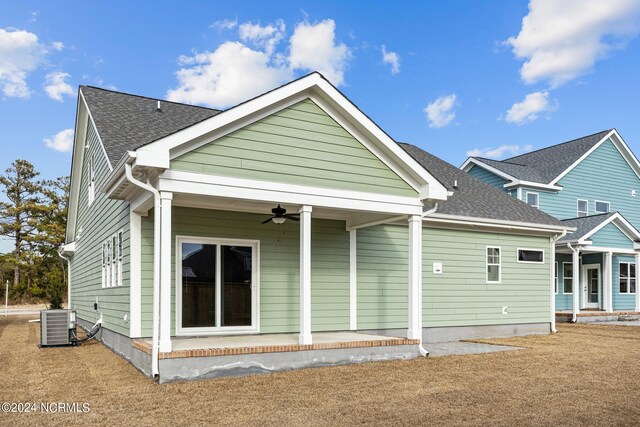 rear view of property featuring ceiling fan and central air condition unit