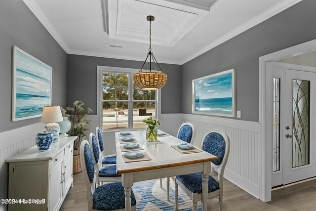 unfurnished dining area with light hardwood / wood-style floors and ornamental molding