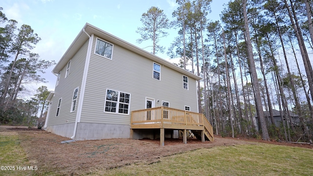 back of property featuring a yard and a deck