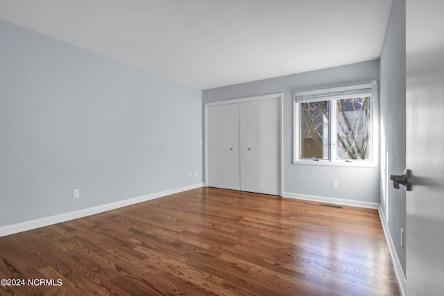 empty room with dark wood-type flooring