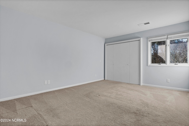 unfurnished room with light colored carpet