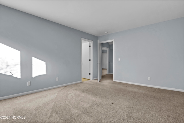 spare room with light colored carpet