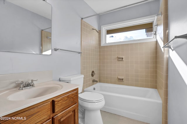 full bathroom with tile flooring, toilet, oversized vanity, and tiled shower / bath