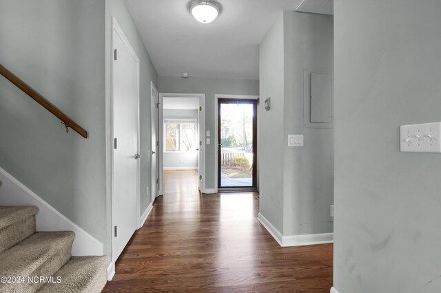 unfurnished living room with a high end fireplace, dark hardwood / wood-style flooring, ceiling fan, and a wealth of natural light