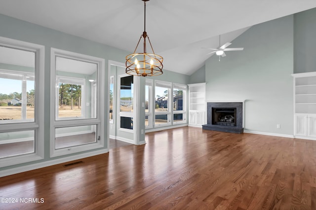 unfurnished living room featuring dark hardwood / wood-style flooring, a high end fireplace, high vaulted ceiling, and ceiling fan with notable chandelier