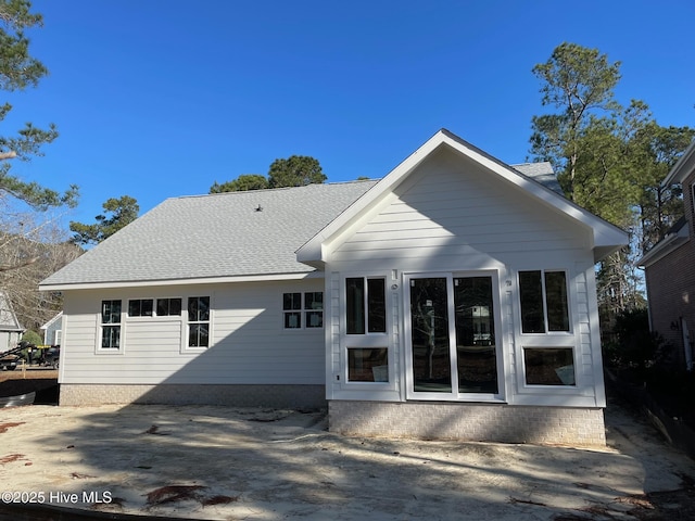 rear view of property with a shingled roof