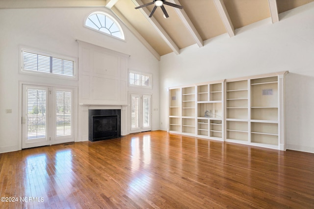 unfurnished living room featuring high vaulted ceiling, ceiling fan, a tile fireplace, and light hardwood / wood-style flooring