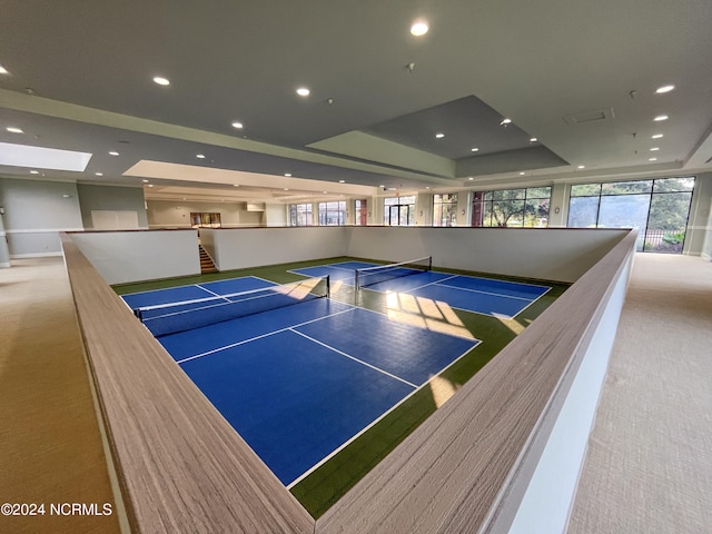 playroom with light carpet and a tray ceiling