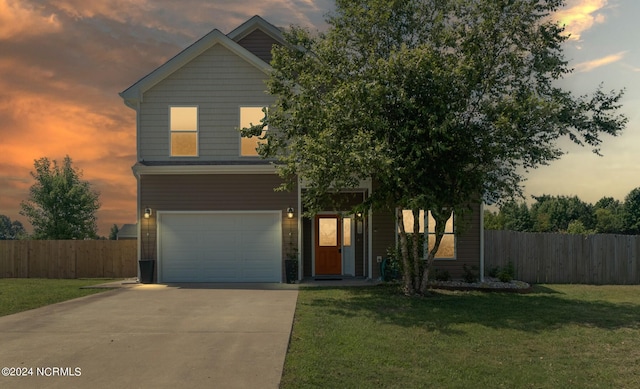 view of front of property with a garage and a lawn