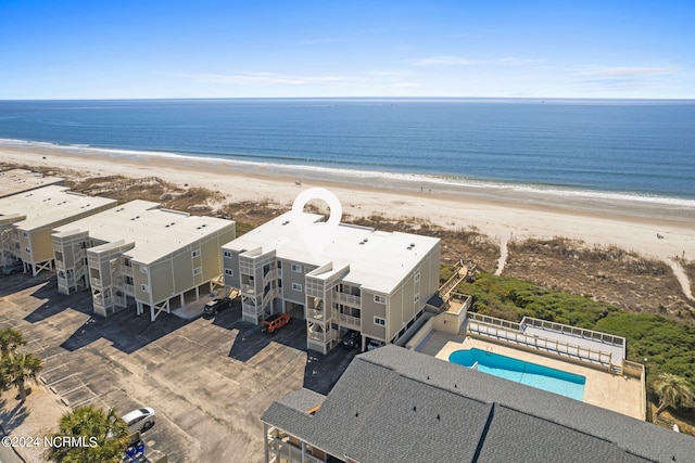 drone / aerial view featuring a water view and a view of the beach