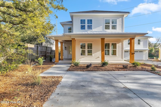 view of front of house with covered porch and a garage