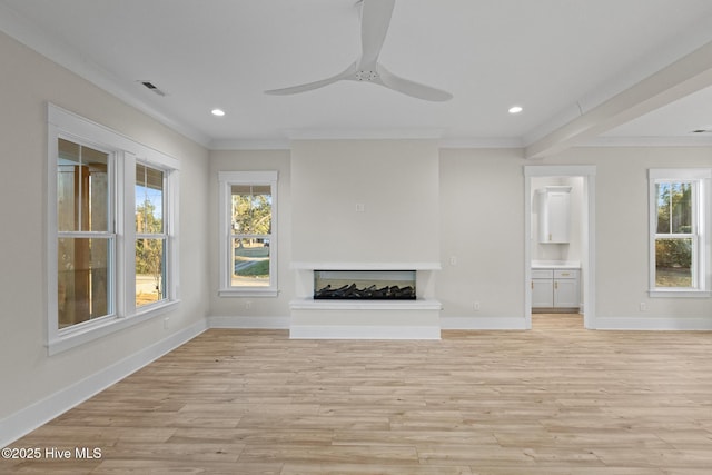 unfurnished living room featuring a multi sided fireplace, crown molding, ceiling fan, and light hardwood / wood-style floors