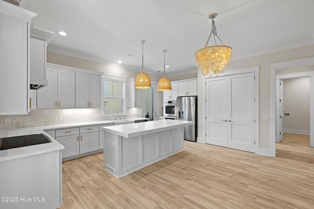 kitchen featuring hanging light fixtures, white cabinetry, decorative backsplash, a kitchen island, and stainless steel fridge with ice dispenser