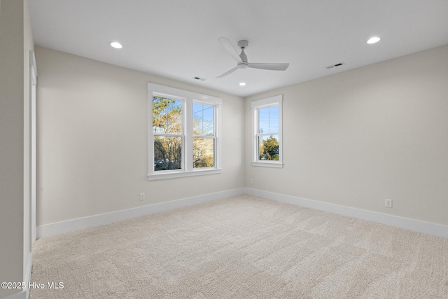 spare room with light carpet and ceiling fan