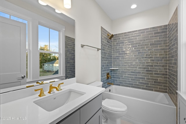 full bathroom with vanity, toilet, and tiled shower / bath