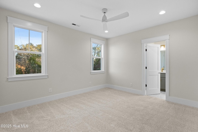 spare room with light carpet and ceiling fan