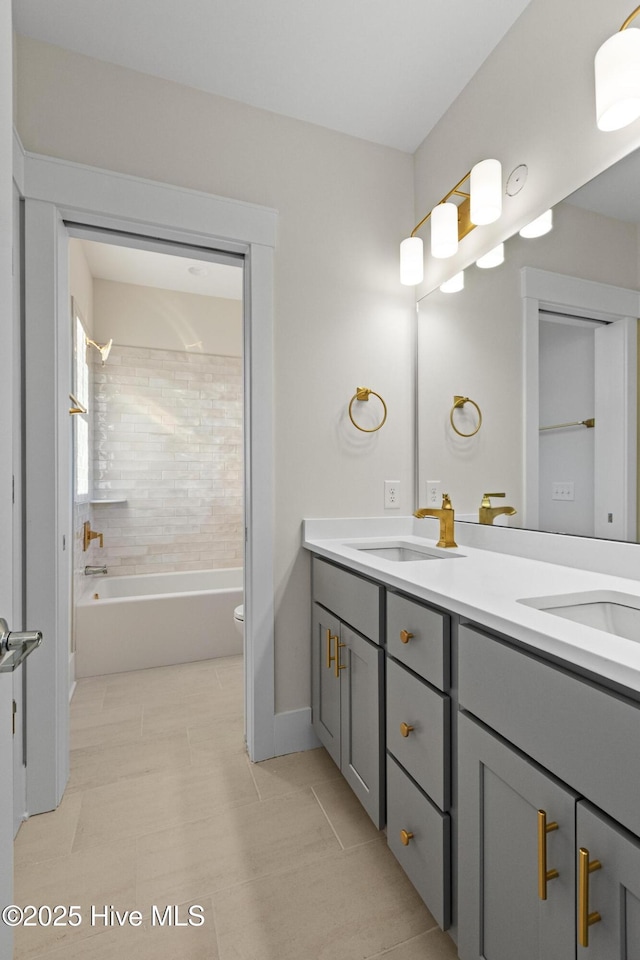 full bathroom with vanity, tiled shower / bath combo, and toilet