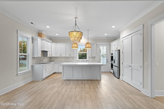 kitchen with pendant lighting, a center island, white cabinets, decorative backsplash, and ornamental molding