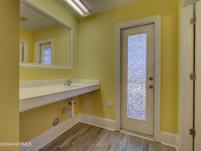 interior space featuring plenty of natural light, sink, and hardwood / wood-style floors