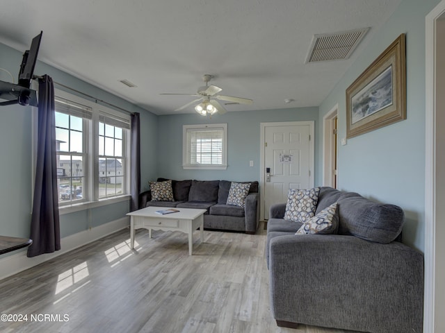 living room featuring light hardwood / wood-style flooring and ceiling fan