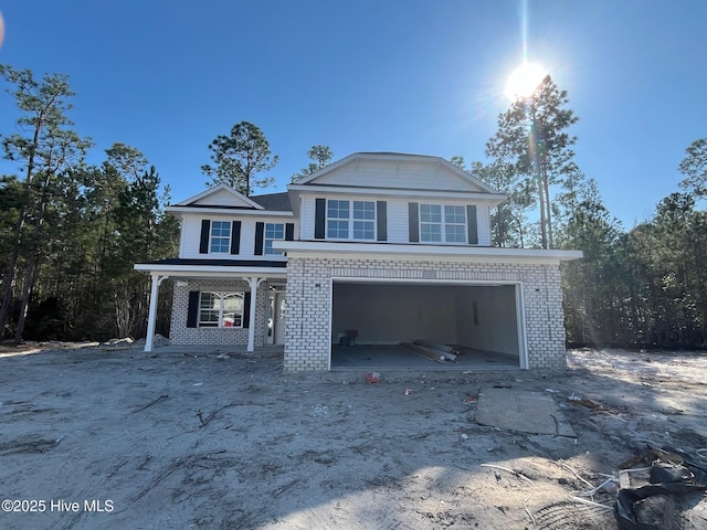 view of front of house with a garage and brick siding