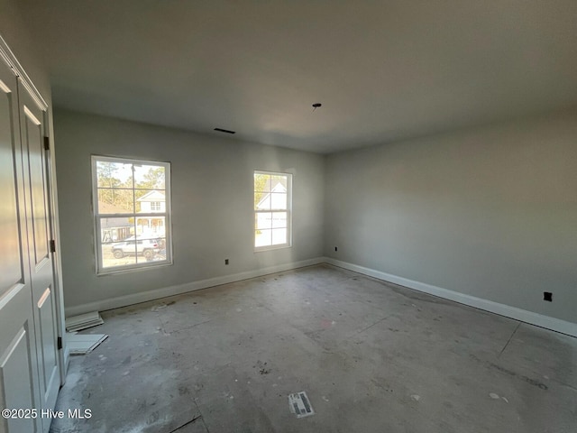 1225 Mandevilla Dr SE, Bolivia, NC 28422 - unfurnished room featuring baseboards and unfinished concrete floors