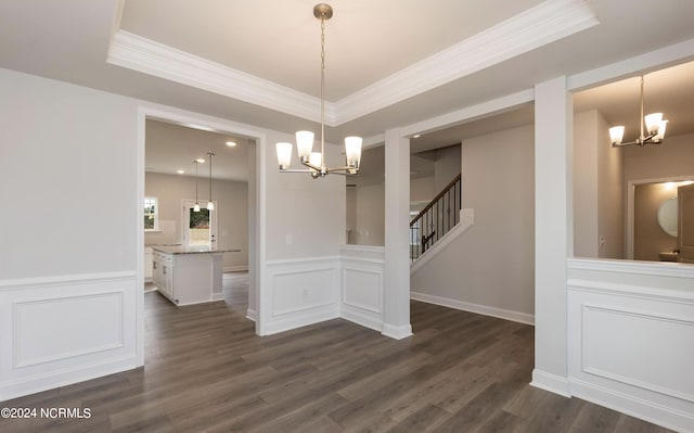 1225 Mandevilla Dr SE, Bolivia, NC 28422 - unfurnished dining area with a chandelier, crown molding, a decorative wall, dark wood finished floors, and a tray ceiling