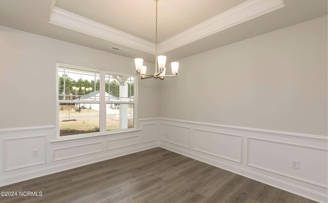 1225 Mandevilla Dr SE, Bolivia, NC 28422 - unfurnished dining area featuring a chandelier, crown molding, a raised ceiling, wainscoting, and dark wood-type flooring