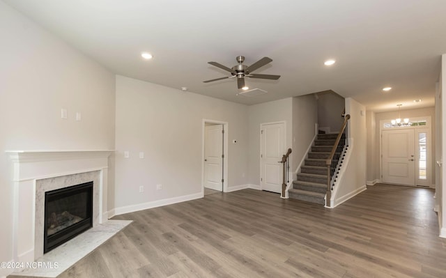 1225 Mandevilla Dr SE, Bolivia, NC 28422 - unfurnished living room with stairway, wood finished floors, a chandelier, ceiling fan, and recessed lighting