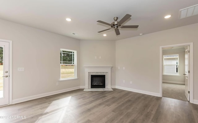 1225 Mandevilla Dr SE, Bolivia, NC 28422 - unfurnished living room featuring a ceiling fan, wood finished floors, a high end fireplace, baseboards, and recessed lighting