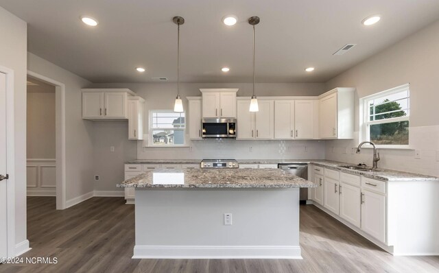 1225 Mandevilla Dr SE, Bolivia, NC 28422 - kitchen featuring appliances with stainless steel finishes, a sink, white cabinets, wood finished floors, and a kitchen island