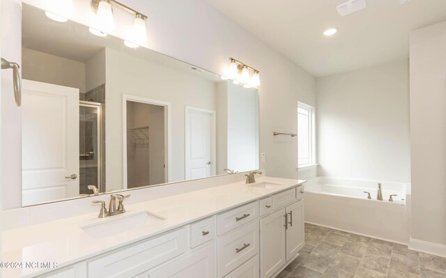1225 Mandevilla Dr SE, Bolivia, NC 28422 - bathroom with a stall shower, a bath, double vanity, recessed lighting, and a spacious closet